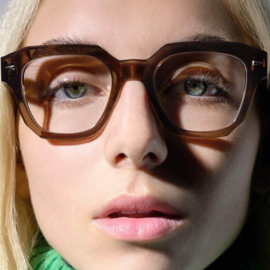 Close up of woman wearing Ahlem glasses with timeless designer frames.