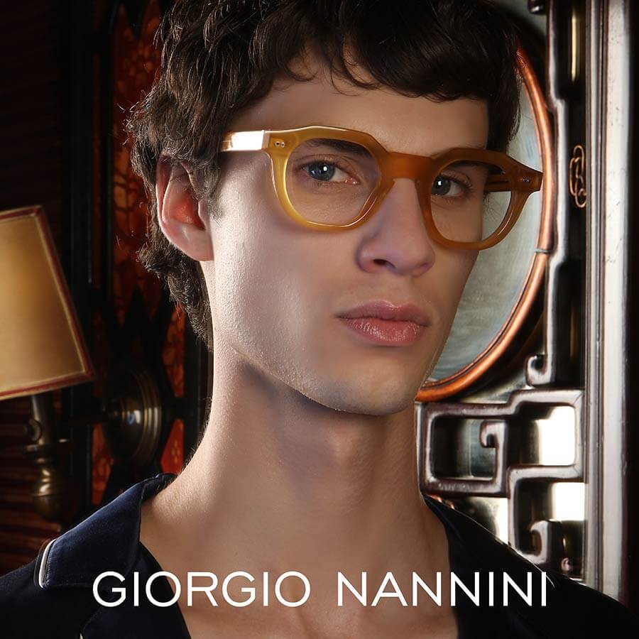 A male model wearing Giorgio Nannini glasses with coloured chunky frames.