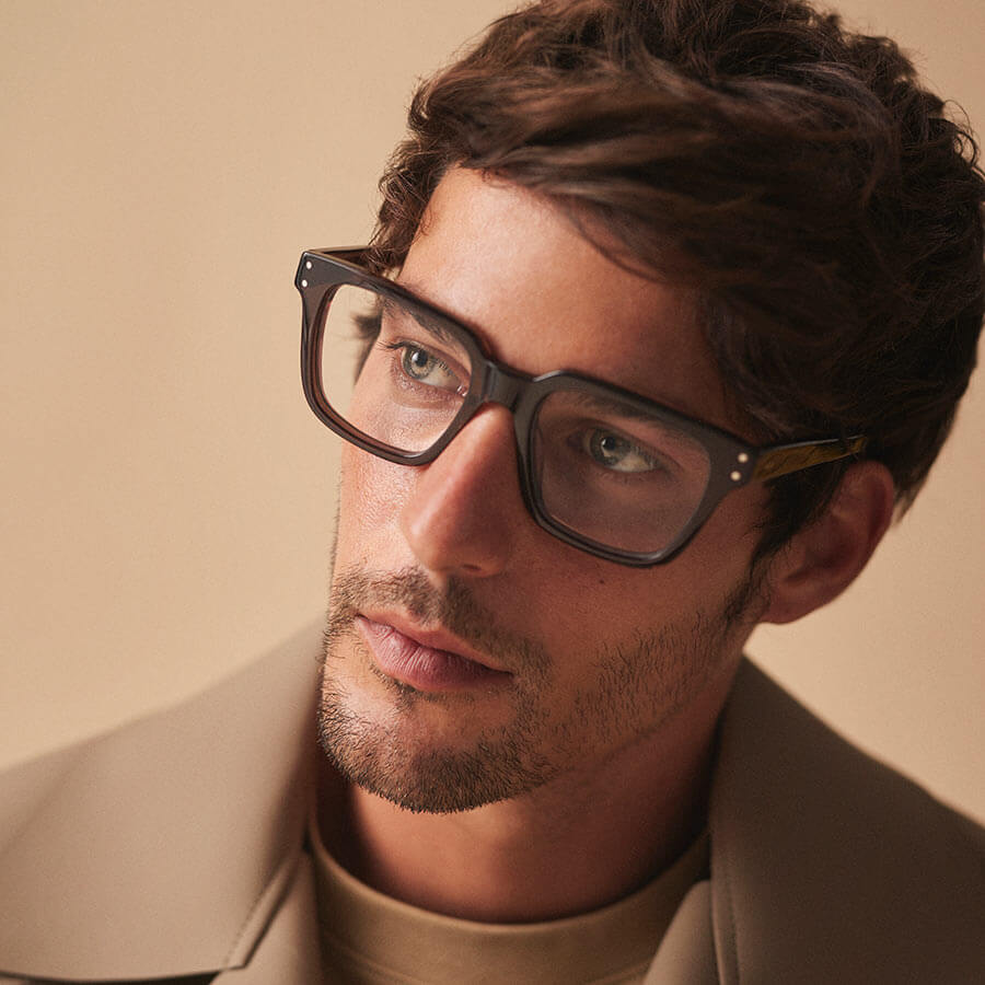 Man wearing a timeless style pair of Kaleos glasses, with classic thick frames.