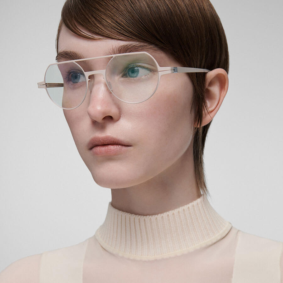 Model wearing lool eyewear with delicate and bold, geometric lines.