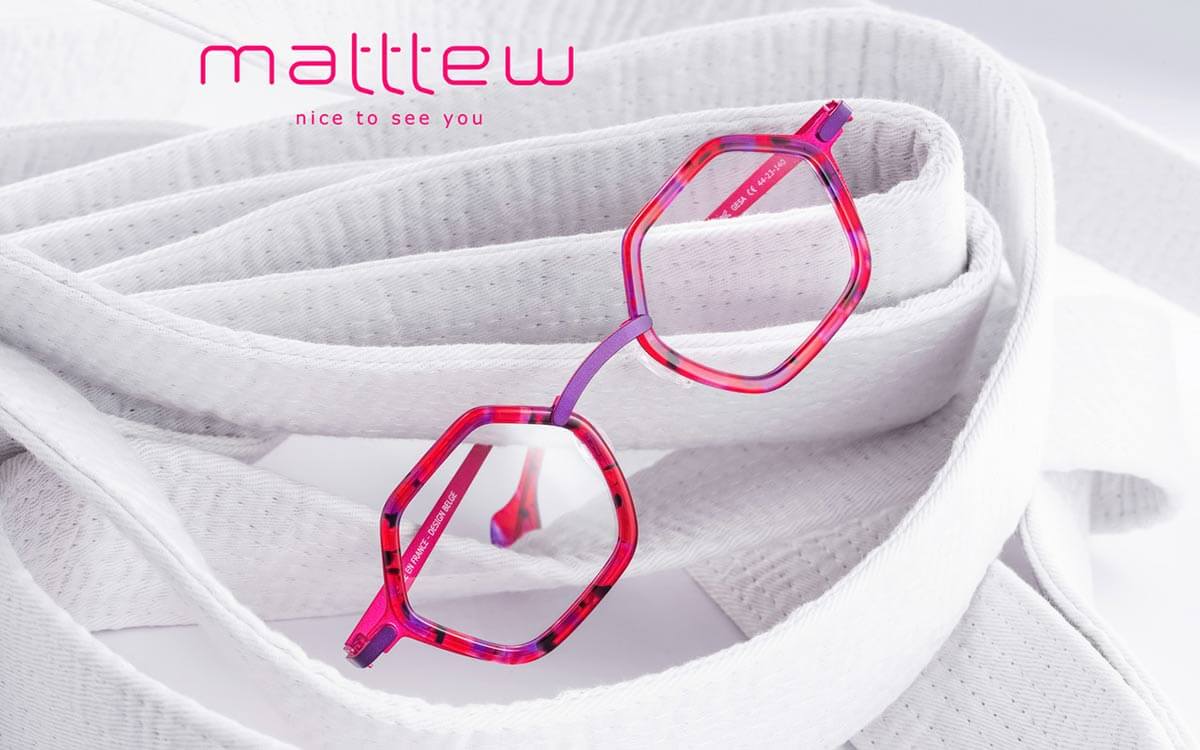 Eye-catching electric pink glasses by Matttew eyewear, with geometric shapes and titanium frames.
